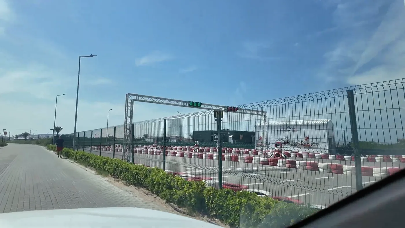 The start gantry with its traffic light seen over the fence (May 2025)